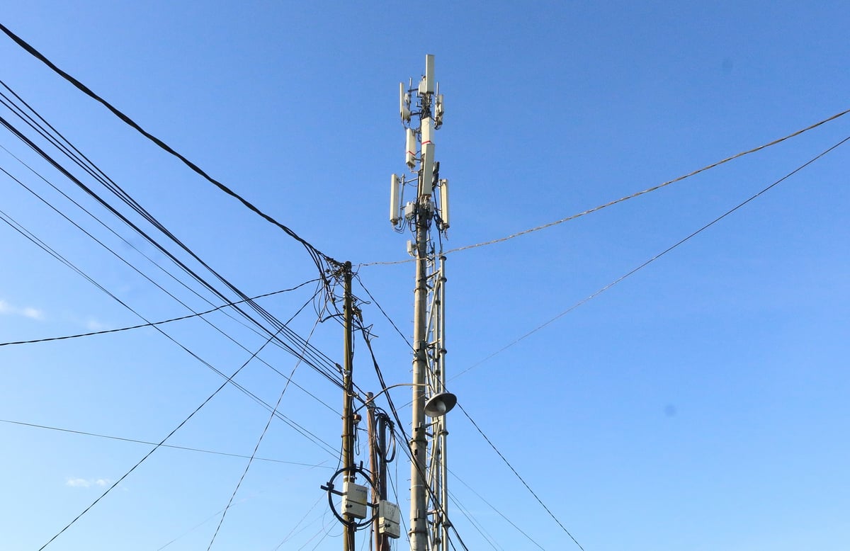 Telecommunications towers and utility poles against the sky